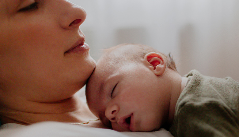 Photo of a mother and sleeping baby
