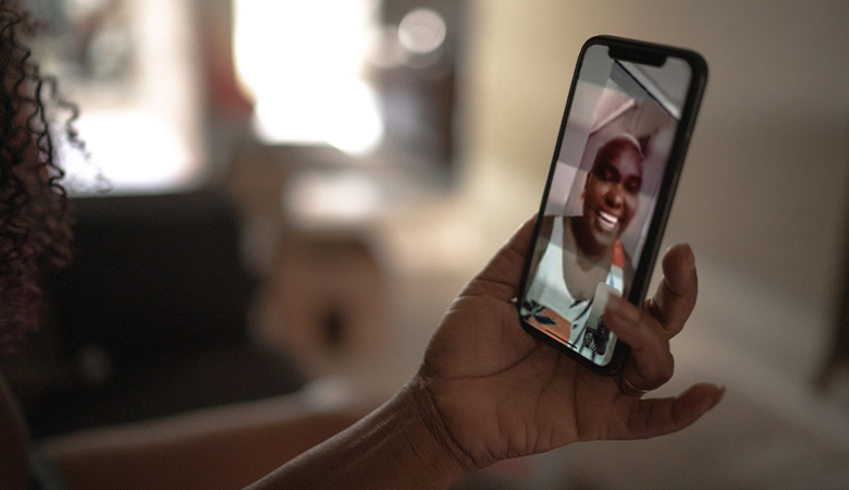 Photo of two individuals conversing on a video call