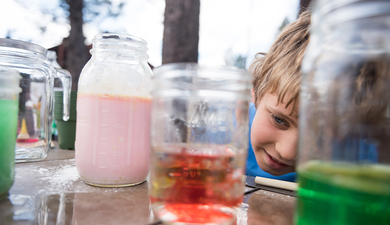 Young student experimenting with science learning at home