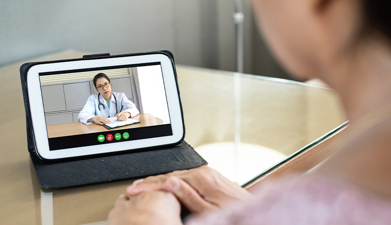 photo of a person talking with a tele heath doctor on a small tablet