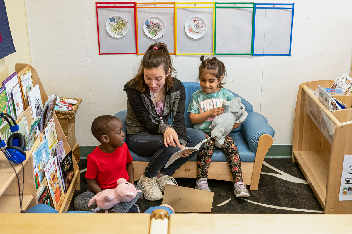 Teacher interacts with early-childhood students in a colorful classroom