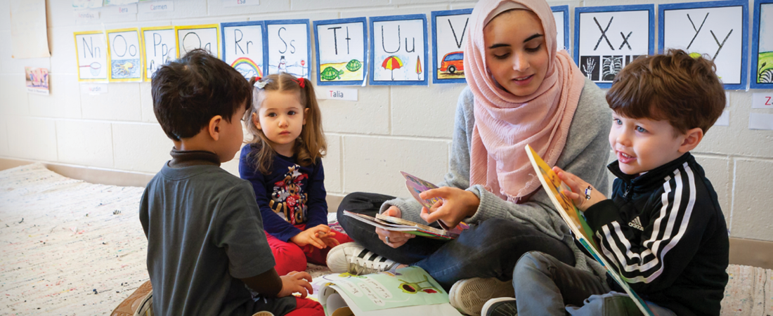A photo of teacher and students in a learning environment
