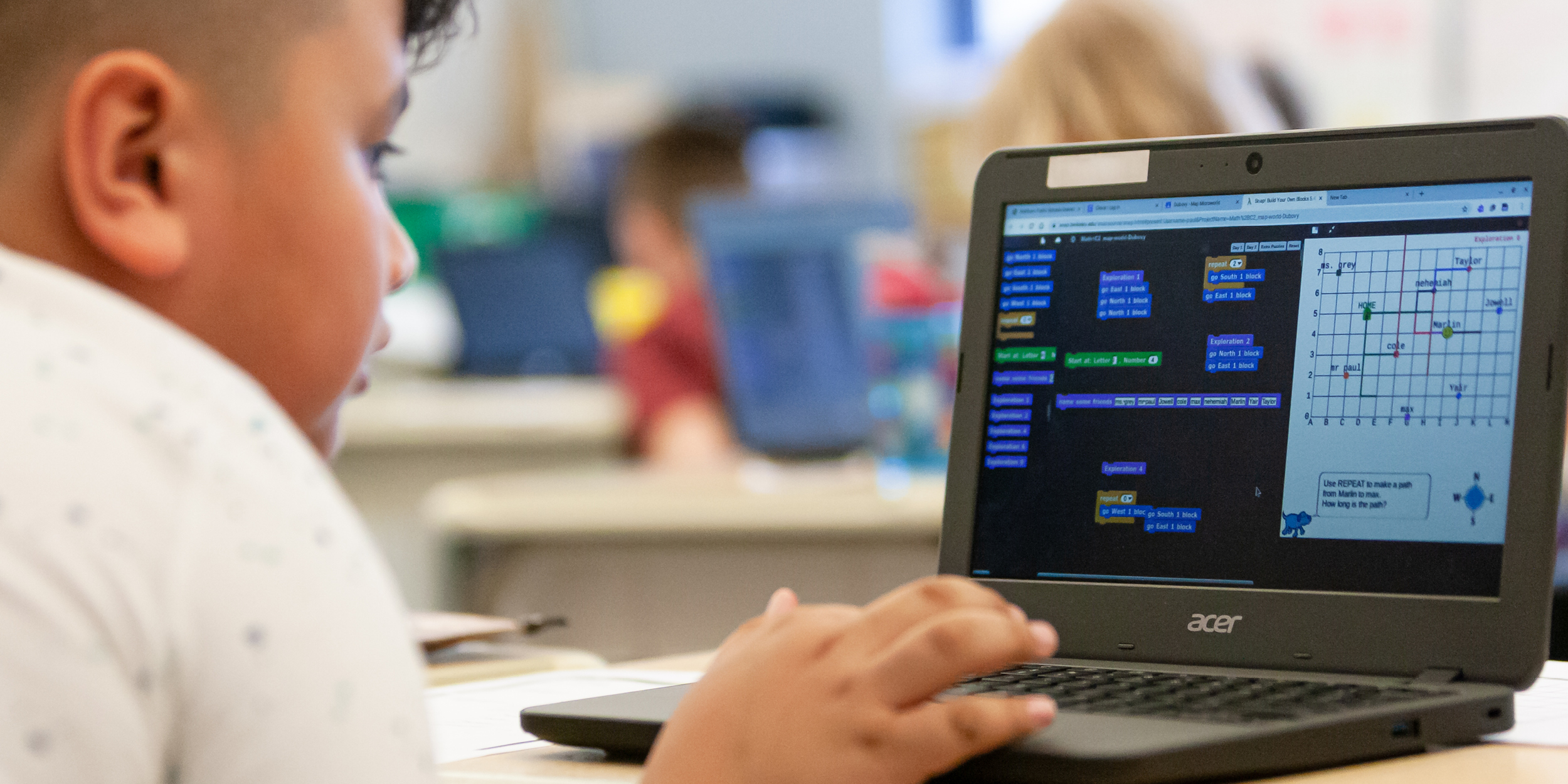 Photo of a child using a computer representing EDC to Lead Project on Integrating Computer Science into Elementary Math